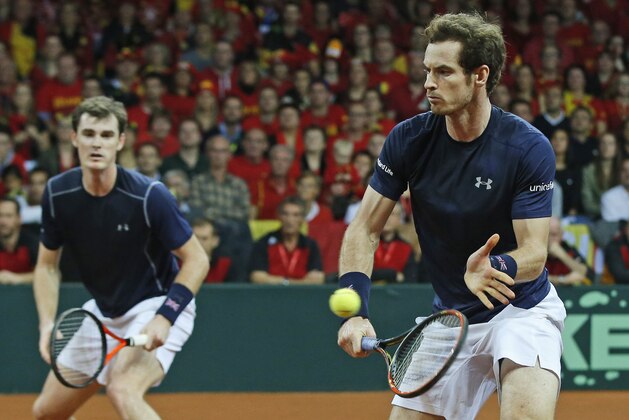 Britain’s Andy Murray, foreground, and his brother Jamie Murray, rear, return against Belgium’s Steve Darcis and David Goffin during their doubles Davis Cup final tennis match at the Flanders Expo in Ghent, Belgium, Saturday, Nov. 28, 2015. (AP Photo/Alastair Grant)