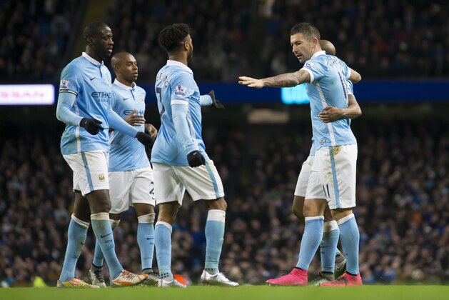 Manchester City's Aleksandar Kolarov, right, celebrates with teammates after scoring during the English Premier League soccer match between Manchester City and Southampton at the Etihad Stadium, Manchester, England, Saturday Nov. 28, 2015. (AP Photo/Jon Super)