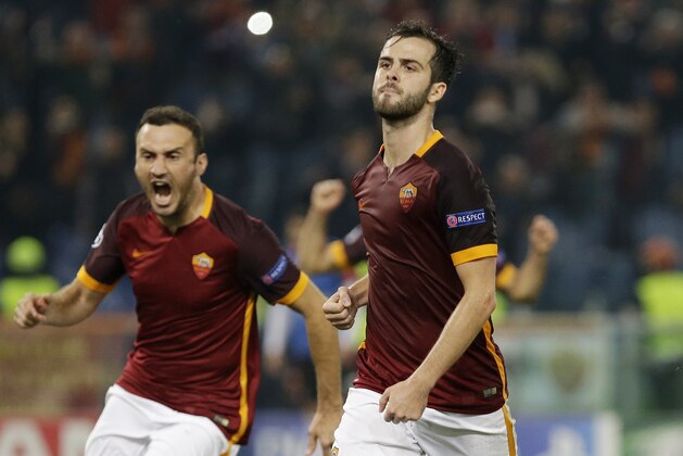 Roma’s Miralem Pjanic, right, celebrates with his teammate Vasilis Torosidis after scoring during the Champions League group E soccer match between Roma and Bayer Leverkusen at the Olympic stadium, in Rome, Italy, Wednesday, Nov. 4, 2015. (AP Photo/Gregorio Borgia)