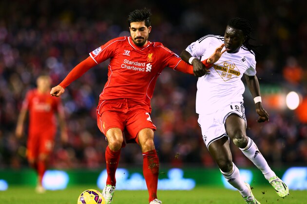 LIVERPOOL, ENGLAND - DECEMBER 29:  Emre Can of Liverpool battles for the ball with Bafetibis Gomis of Swansea City during the Barclays Premier League match between Liverpool and Swansea City at Anfield on December 29, 2014 in Liverpool, England.  (Photo by Clive Brunskill/Getty Images)