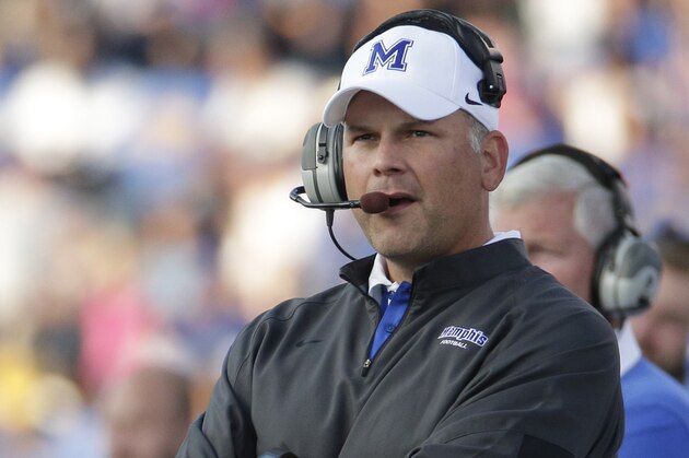 Memphis head coach Justin Fuente watches during the first half of an NCAA college football game against Kansas Saturday, Sept. 12, 2015, in Lawrence, Kan. (AP Photo/Charlie Riedel)