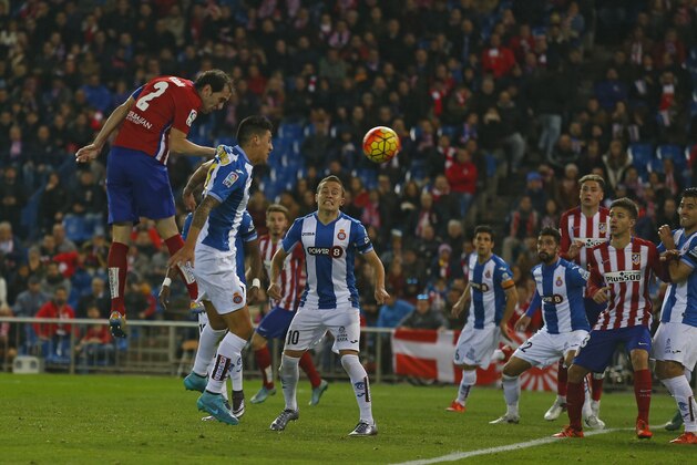 Atletico Madrid's Diego Godin, top left, out jumps other players to head the ball during a Spanish La Liga soccer match between Atletico Madrid and Espanyol at the Vicente Calderon stadium in Madrid, Saturday, Nov. 28, 2015. Atletico won 1-0. (AP Photo/Francisco Seco)