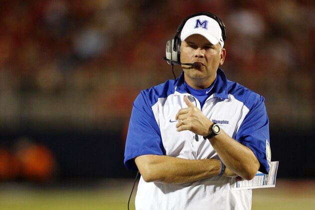 Memphis football coach Justin Fuente talks on his headset in the second half of an NCAA college football game against Mississippi in Oxford, Miss., Saturday, Sept. 27, 2014. No. 10 Mississippi won 24-3. (AP Photo/Rogelio V. Solis)