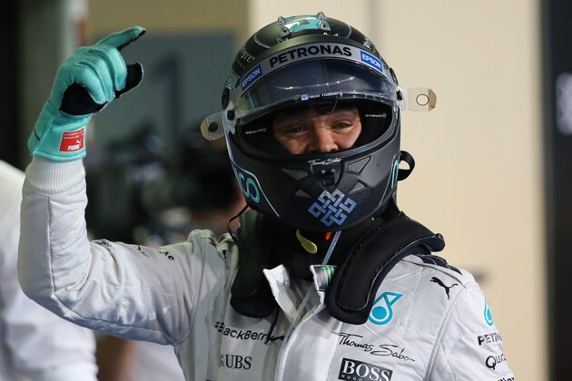 Mercedes AMG Petronas F1 Team's German driver Nico Rosberg celebrates after the qualifying session at the Yas Marina circuit in Abu Dhabi on November 28, 2015 ahead of the Abu Dhabi Formula One Grand Prix. Rosberg will start from pole position in the final Grand Prix of the season in Abu Dhabi after coming home fastest in qualifying.   AFP PHOTO / MARWAN NAAMANI / AFP / MARWAN NAAMANI        (Photo credit should read MARWAN NAAMANI/AFP/Getty Images)