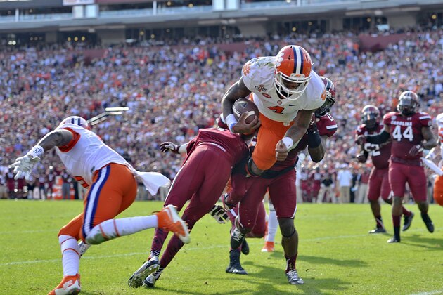 Clemson quarterback Deshaun Watson (4) dives into the endzone for a 5-yard touchdown run during the first half of an NCAA college football game against South Carolina, Saturday,  Nov. 28, 2015,  in Columbia,  S.C. (AP Photo/Richard Shiro)