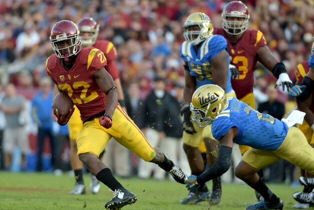 Nov 28, 2015; Los Angeles, CA, USA; Southern California Trojans running back Justin Davis (22) is defended by UCLA Bruins defensive back Jaleel Wadood (2) during an NCAA football game at Los Angeles Memorial Coliseum. USC defeated UCLA 40-21. Mandatory Credit: Kirby Lee-USA TODAY Sports