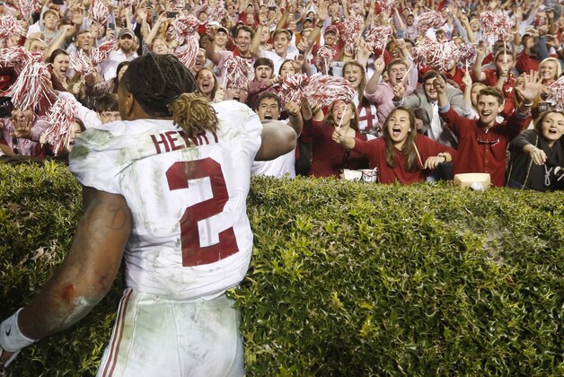 Fans cheer for Alabama running back Derrick Henry (2) after an NCAA college football game, Saturday, Nov. 28, 2015, in Auburn, Ala. Alabama won 29-13. (AP Photo/Gerald Herbert)
