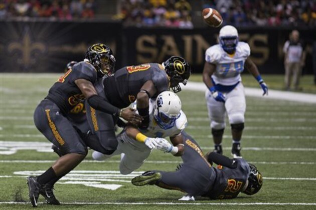 Southern University Jaguars running back Lenard Tillery (21) loses the ball after being tackled by Grambling State in the first half of the Bayou Classic NCAA college football game in New Orleans, Saturday, Nov. 28, 2015. Southern University recovered the ball in the play.  (AP Photo/Max Becherer)