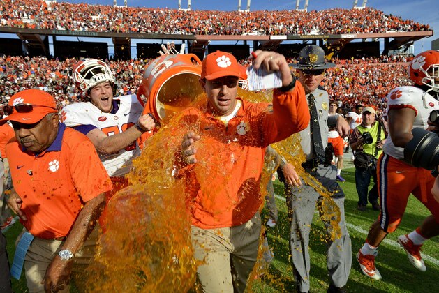 Clemson head coach Dabo Swinney gets dunked by Jim Brown after an NCAA college football game against South Carolina Saturday,  Nov. 28, 2015,  in Columbia,  S.C. Clemson won 37-32. (AP Photo/Richard Shiro)