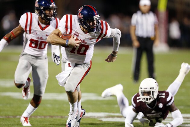 Mississippi quarterback Chad Kelly (10) runs with the ball past Mississippi State defensive back Kivon Coman (11) for a 27-yard touchdown run in the first half of an NCAA college football game against Mississippi in Starkville, Miss., Saturday, Nov. 28, 2015. (AP Photo/Rogelio V. Solis)