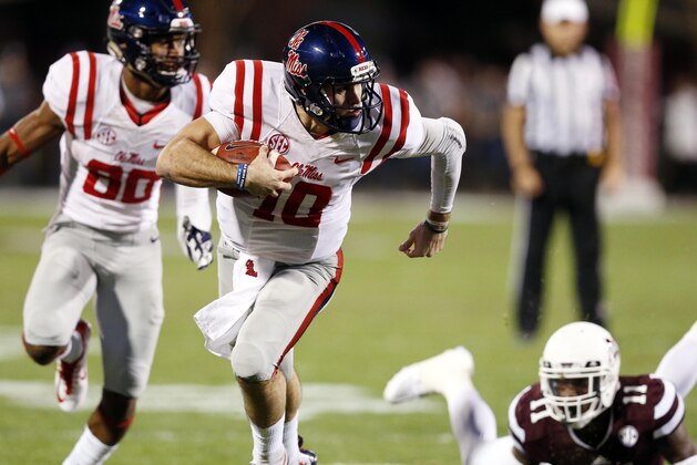 Mississippi quarterback Chad Kelly (10) runs with the ball past Mississippi State defensive back Kivon Coman (11) for a 27-yard touchdown run in the first half of an NCAA college football game against Mississippi in Starkville, Miss., Saturday, Nov. 28, 2015. (AP Photo/Rogelio V. Solis)