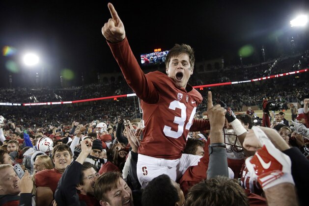 Stanford place kicker Conrad Ukropina (34) is lifted by fans and teammates after hitting a 45-yard field goal as time expired to give Stanford a 38-36 win over Notre Dame in an NCAA college football game Saturday, Nov. 28, 2015, in Stanford, Calif. (AP Photo/Marcio Jose Sanchez)
