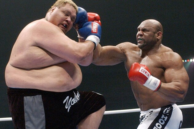 NAGOYA, JAPAN:  Hawaiian-born former sumo wrestler Taro Akebono (L) and American former NFL player Bob Sapp fight in a K-1 bout in Nagoya, central Japan, 31 December 2003. Sapp won by technical knockout. Akebono, Japan's first foreign-born sumo grand champion, made his debut in the match of K-1,  a violent karate-based combat sport. AFP PHOTO/JIJI PRESS  (Photo credit should read JIJI PRESS/AFP/Getty Images)