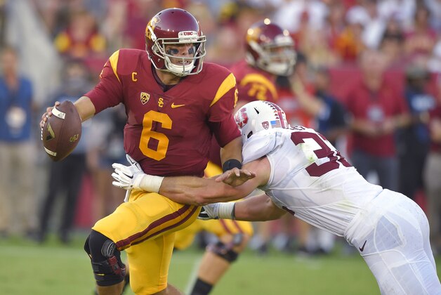 Southern California quarterback Cody Kessler, left, escapes a tackle by Stanford linebacker Joey Alfieri during the first half of an NCAA college football game, Saturday, Sept. 19, 2015, in Los Angeles. (AP Photo/Mark J. Terrill)