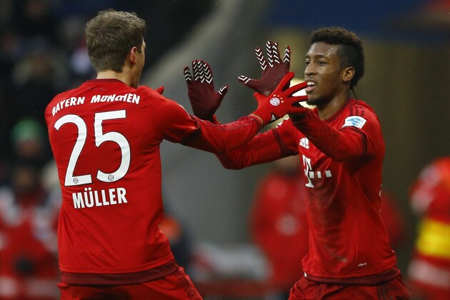 Bayern’s Kingsley Coman, right, celebrates with teammate Thomas Mueller after scoring his side's second goal during the German Bundesliga soccer match between FC Bayern Munich and Hertha BSC Berlin at the Allianz Arena stadium in Munich, Germany, Saturday, Nov. 28, 2015. (AP Photo/Matthias Schrader)