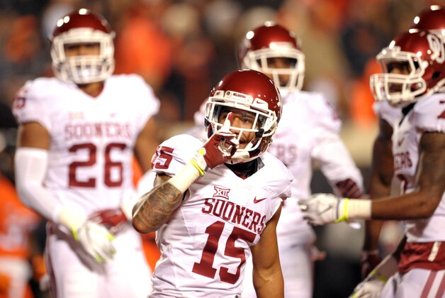 Oklahoma cornerback Zack Sanchez gestures to Oklahoma State fans in the endzone following a teammate's touchdown during an NCAA college football game in Stillwater, Okla., Saturday, Nov. 28, 2015. (AP Photo/Brody Schmidt)