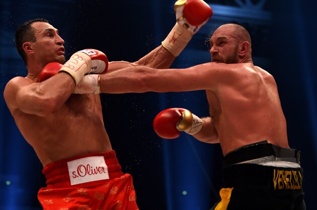 World heavyweight boxing champion Wladimir Klitschko (L) of Ukraine defends against Britain's Tyson Fury during their  WBA, IBF, WBO and IBO title bout in Duesseldorf, western Germany, on November 28, 2015.   Fury dethroned  Klitschko in a 12round decision to become world heavyweight champion. AFP PHOTO / PATRIK STOLLARZ / AFP / PATRIK STOLLARZ        (Photo credit should read PATRIK STOLLARZ/AFP/Getty Images)