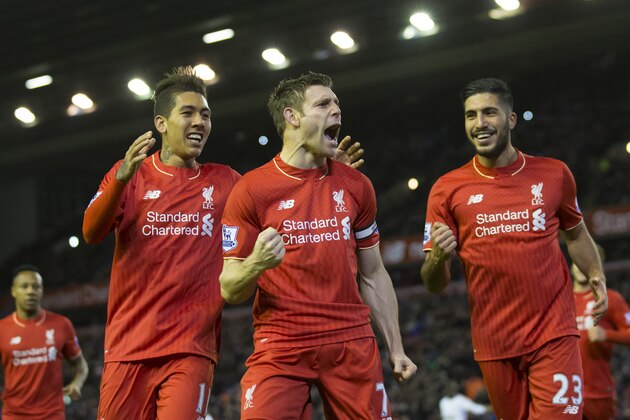 Liverpool's James Milner, centre, celebrates with teammates after scoring a penalty during the English Premier League soccer match between Liverpool and Swansea at Anfield Stadium, Liverpool, England, Sunday, Nov. 29, 2015. (AP Photo/Jon Super)