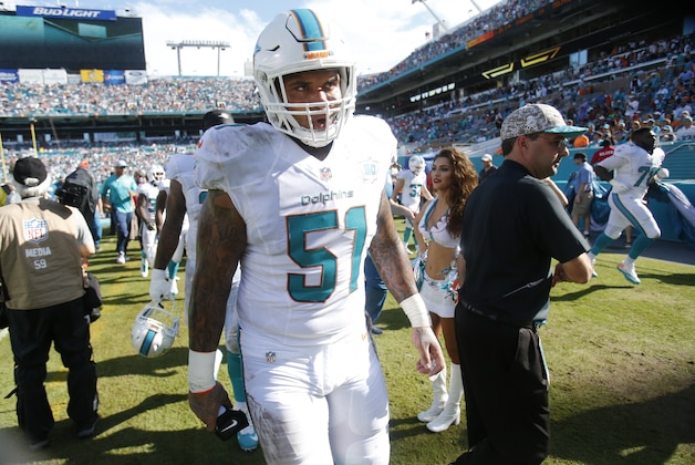 Miami Dolphins center Mike Pouncey walks off the field after the first half of an NFL football game against the Dallas Cowboys, Sunday, Nov. 22, 2015 in Miami Gardens, Fla. (AP Photo/Wilfredo Lee)