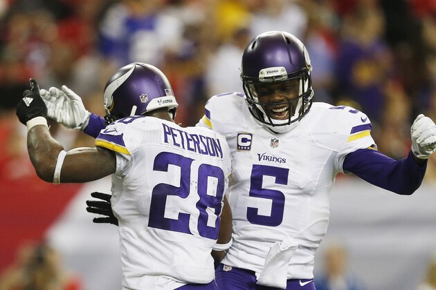 Minnesota Vikings running back Adrian Peterson (28) celebrates his touchdown with Minnesota Vikings quarterback Teddy Bridgewater (5) against the Atlanta Falcons during the second half of an NFL football game, Sunday, Nov. 29, 2015, in Atlanta. (AP Photo/Butch Dill)
