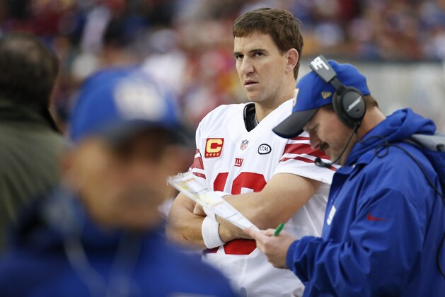 New York Giants quarterback Eli Manning (10) watches the action from the sidelines during the second half of an NFL football game against the Washington Redskins in Landover, Md., Sunday, Nov. 29, 2015. (AP Photo/Alex Brandon)