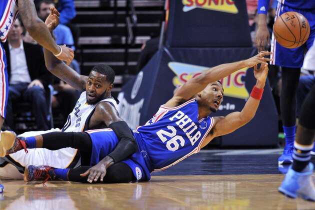 Philadelphia 76ers guard Phil Pressey (26) looses control of the ball after falling to the court along with Memphis Grizzlies forward JaMychal Green, left, in the first half of an NBA basketball game, Sunday, Nov. 29, 2015, in Memphis, Tenn. (AP Photo/Brandon Dill)