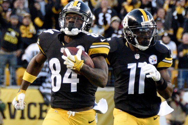 Pittsburgh Steelers wide receiver Antonio Brown (84) runs with Markus Wheaton ahead of Oakland Raiders defenders after making a catch to help set up the Steelers game winning field goal in the fourth quarter of an NFL football game against the Oakland Raiders, Sunday, Nov. 8, 2015, in Pittsburgh. (AP Photo/Don Wright)