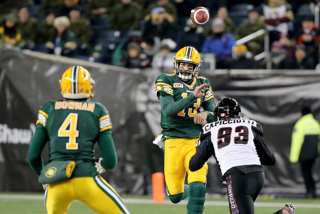 WINNIPEG, CANADA - NOVEMBER 29:  Mike Reilly #13 of the Edmonton Eskimos fires a pass to Adarius Bowman #4 before getting hit by Justin Capicciotti #93 of the Ottawa Redblacks during the first half of Grey Cup 103 at Investors Group Field on November 29, 2015 in Winnipeg, Manitoba, Canada. (Photo by Trevor Hagan/Getty Images)