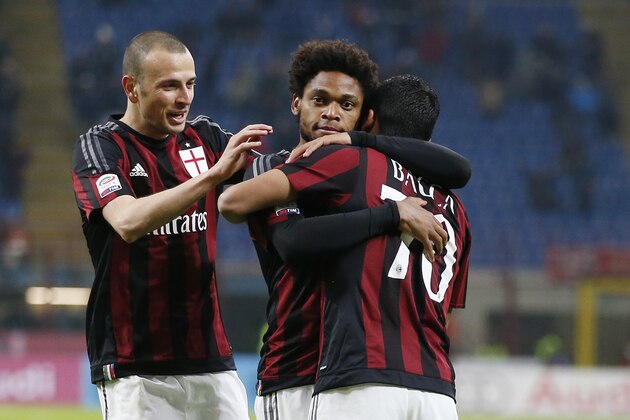 AC Milan's Adriano, center, celebrates with his teammates Carlos Bacca, right, and Luca Antonelli after scoring during the Serie A soccer match between AC Milan and Sampdoria at the San Siro stadium in Milan, Italy, Saturday, Nov. 28 , 2015. (AP Photo/Antonio Calanni)