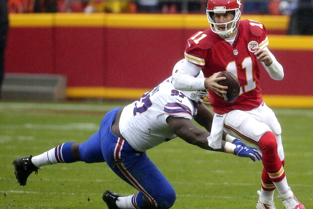 Kansas City Chiefs quarterback Alex Smith (11) runs past a tackle attempt by Buffalo Bills defensive tackle Corbin Bryant (97) during the first half of an NFL football game in Kansas City, Mo., Sunday, Nov. 29, 2015. (AP Photo/Charlie Riedel)
