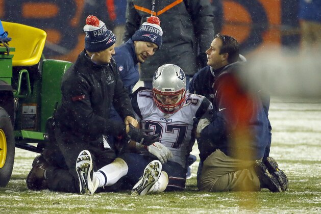 New England Patriots tight end Rob Gronkowski (87) is attended to after being injured against the Denver Broncos during the second half of an NFL football game, Sunday, Nov. 29, 2015, in Denver. (AP Photo/Jack Dempsey)