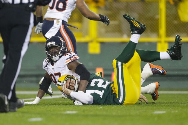 GREEN BAY, WI - NOVEMBER 26:  Quarterback  Aaron Rodgers #12 of the Green Bay Packers falls down after getting hit by Willie Young #97 of the Chicago Bears in the first quarter at Lambeau Field on November 26, 2015 in Green Bay, Wisconsin.  (Photo by Mike McGinnis/Getty Images)