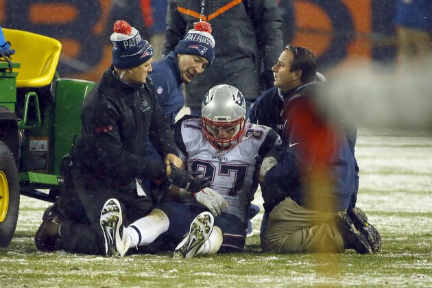 New England Patriots tight end Rob Gronkowski (87) is attended to after being injured against the Denver Broncos during the second half of an NFL football game, Sunday, Nov. 29, 2015, in Denver. (AP Photo/Jack Dempsey)