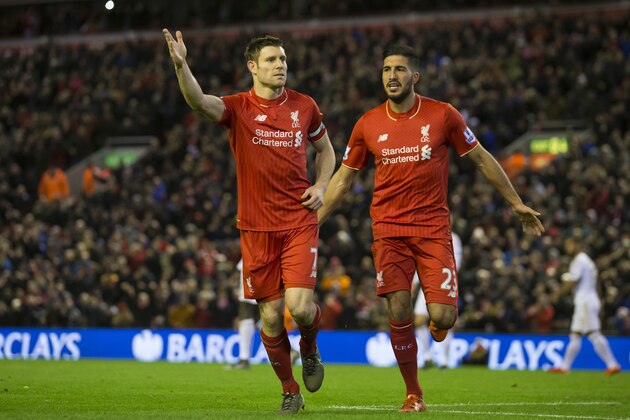 Liverpool's James Milner, left, celebrates with teammate Emre Can after scoring a penalty during the English Premier League soccer match between Liverpool and Swansea at Anfield Stadium, Liverpool, England, Sunday, Nov. 29, 2015. (AP Photo/Jon Super)