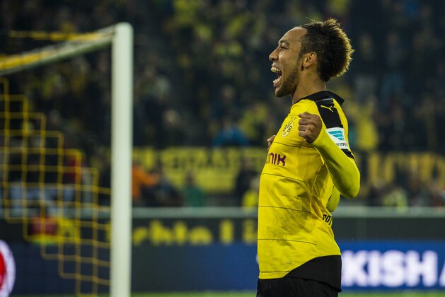 Dortmund's Gabonese midfielder Pierre-Emerick Aubameyang celebrates scoring his side's 5th goal to complete his hat-trick during the German first division football Bundesliga match between Borussia Dortmund and FC Augsburg on October 25, 2015 in Dortmund, western Germany. Dortmund won the match 5-1. AFP PHOTO / ODD ANDERSEN
RESTRICTIONS: DURING MATCH TIME: DFL RULES TO LIMIT THE ONLINE USAGE TO 15 PICTURES PER MATCH AND FORBID IMAGE SEQUENCES TO SIMULATE VIDEO. 
==RESTRICTED TO EDITORIAL USE ==
FOR FURTHER QUERIES PLEASE CONTACT THE DFL DIRECTLY AT + 49 69 650050.        (Photo credit should read ODD ANDERSEN/AFP/Getty Images)
