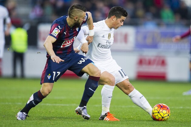 EIBAR, SPAIN - NOVEMBER 29:  James Rodriguez of Real Madrid duels for the ball with David Junca of SD Eibar during the La Liga match between SD Eibar and Real Madrid at Ipurua Municipal Stadium on November 29, 2015 in Eibar, Spain.  (Photo by Juan Manuel Serrano Arce/Getty Images)