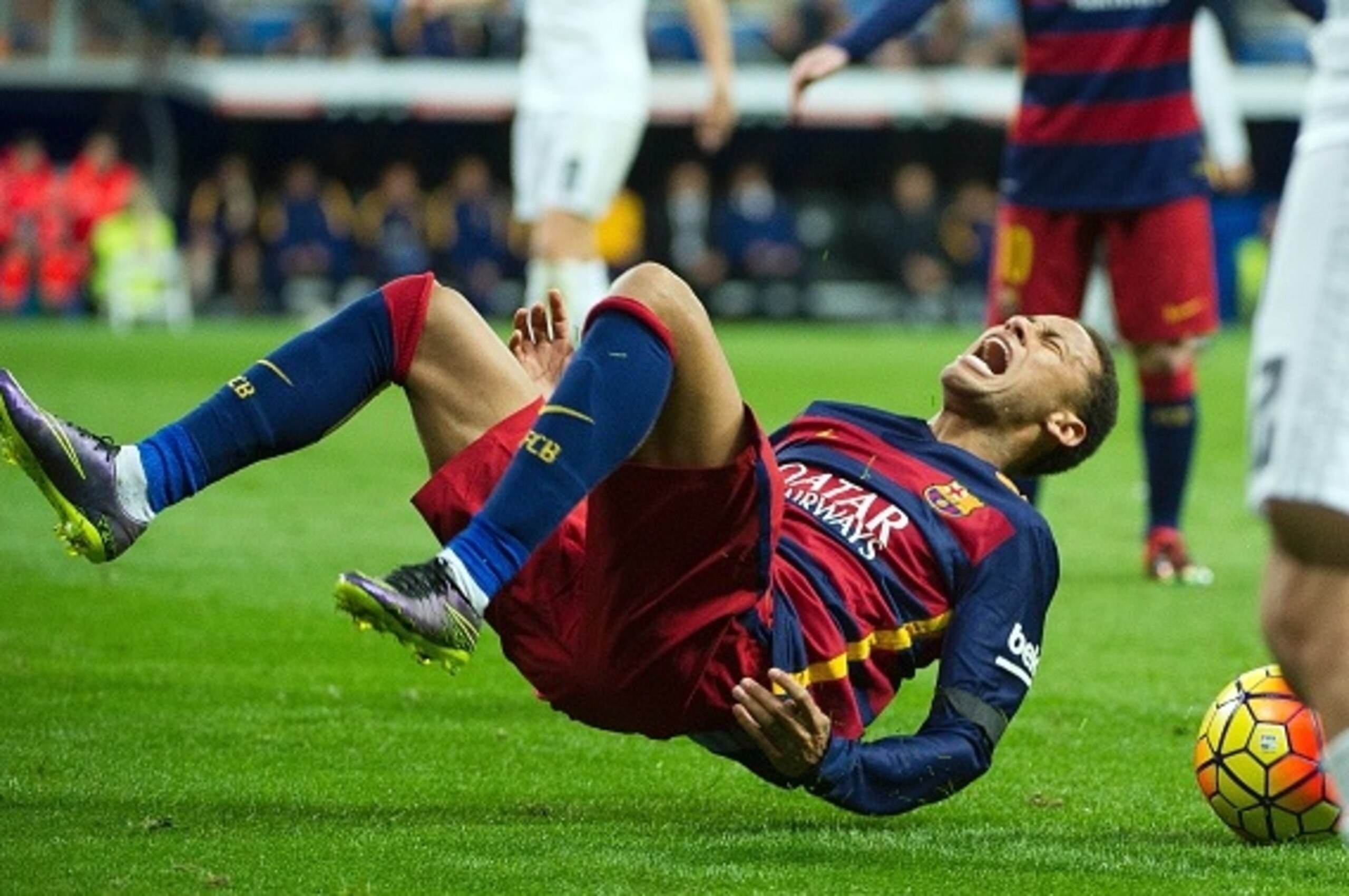 Barcelona's Brazilian forward Neymar falls down after being tackled during the Spanish league 'Clasico' football match Real Madrid CF vs FC Barcelona at the Santiago Bernabeu stadium in Madrid on November 21, 2014.  / AFP / CURTO DE LA TORRE        (Photo credit should read CURTO DE LA TORRE/AFP/Getty Images)