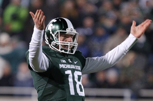 Michigan State quarterback Connor Cook encourages the crowd during the fourth quarter of an NCAA college football game against Penn State, Saturday, Nov. 28, 2015, in East Lansing, Mich. Michigan State won 55-16. (AP Photo/Al Goldis)
