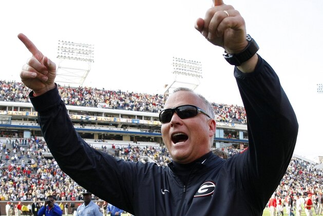 FILE - In this Nov. 28, 2015, file photo, Georgia head coach Mark Richt celebrates as he walks off the field after his team defeated Georgia Tech 13-7 in an NCAA college football game in Atlanta, Ga. Richt is stepping down after 15 seasons in what is being called a