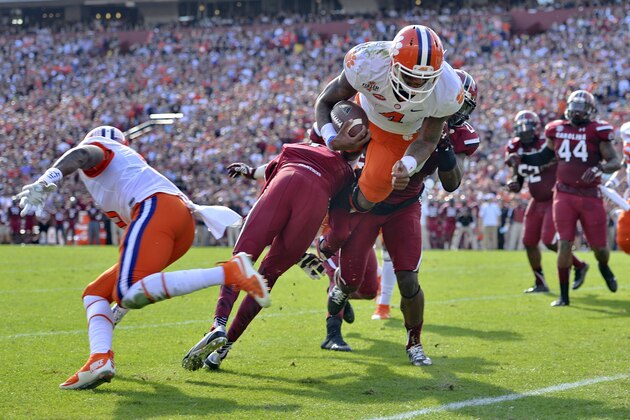Clemson quarterback Deshaun Watson (4) dives into the endzone for a 5-yard touchdown run during the first half of an NCAA college football game against South Carolina, Saturday,  Nov. 28, 2015,  in Columbia,  S.C. (AP Photo/Richard Shiro)