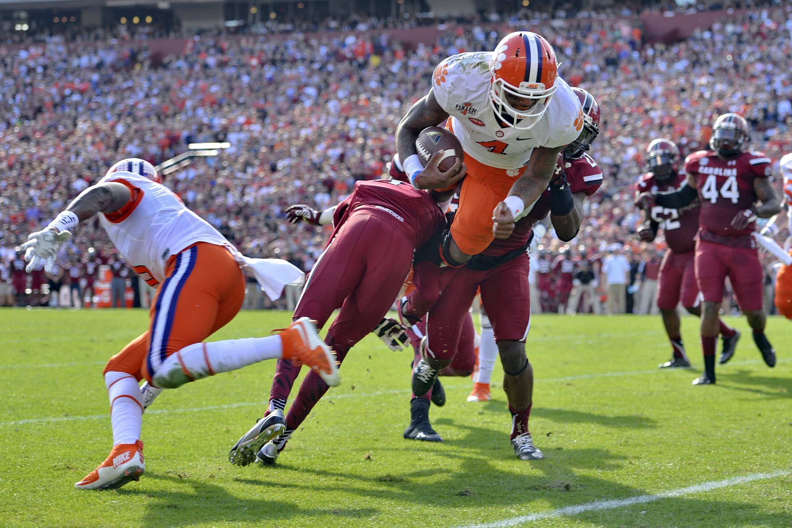 Clemson quarterback Deshaun Watson (4) dives into the endzone for a 5-yard touchdown run during the first half of an NCAA college football game against South Carolina, Saturday,  Nov. 28, 2015,  in Columbia,  S.C. (AP Photo/Richard Shiro)