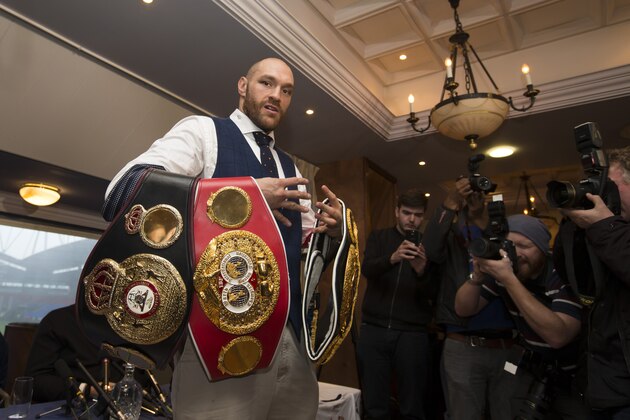 Newly crowned heavyweight world boxing champion Tyson Fury poses for photographs as he hosts a media day in Bolton, England, Monday, Nov. 30, 2015. The 27-year-old Briton defeated 39-year-old Ukrainian Wladimir Klitschko in Dusseldorf, Germany on Saturday to become the WBA, IBF and WBO heavyweight champion. (AP Photo/Jon Super)