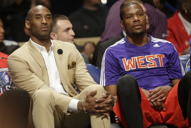 Los Angeles Lakers Kobe Bryant, left, sits with West Team's Kevin Durant, of the Oklahoma City Thunder during the NBA All Star basketball game, Sunday, Feb. 16, 2014, in New Orleans. (AP Photo/Gerald Herbert)