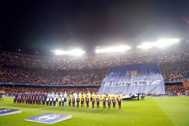 The players of Barcelona, left, and BATE line up on the pitch while F.C Barcelona supporters wave Estelada, or pro-independece flags, distributed by separatists groups ahead of the Champions League Group E soccer match between FC Barcelona and BATE Borisov at the Camp Nou stadium in Barcelona, Spain, Wednesday, Nov. 4, 2015. A longtime bastion of the separatist movement for the northeastern region of Catalonia, Barcelona’s Camp Nou Stadium was again bristling with pro-independence “estelada” flags handed out by separatists groups on Wednesday.(AP Photo/Manu Fernandez)