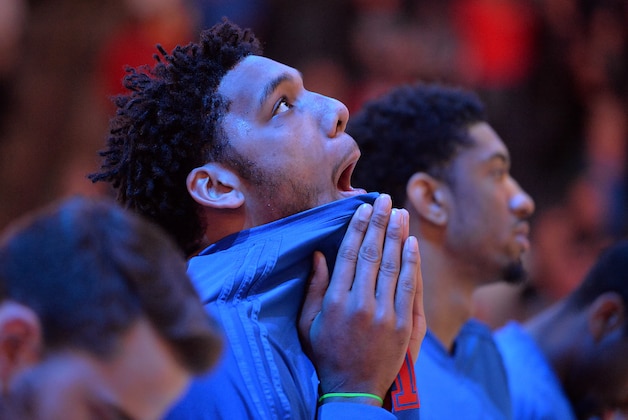 Philadelphia 76ers center Jahlil Okafor stands on the court during the singing of the National Anthem before an NBA basketball game against the Memphis Grizzlies Sunday, Nov. 29, 2015, in Memphis, Tenn. (AP Photo/Brandon Dill)