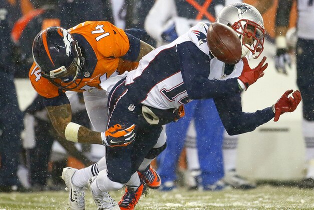 New England Patriots wide receiver Chris Harper (14) fumbles on a punt return as Denver Broncos wide receiver Cody Latimer (14) defends during the second half of an NFL football game, Sunday, Nov. 29, 2015, in Denver. The Broncos recovered the ball. (AP Photo/Jack Dempsey)