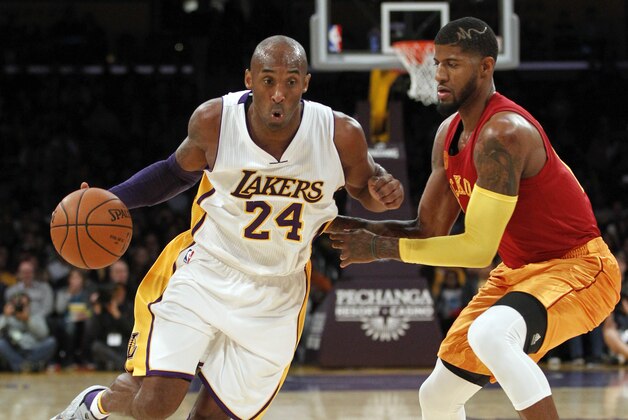 Los Angeles Lakers forward Kobe Bryant (24) drives past Indiana Pacers forward Paul George, right, during the first half of an NBA basketball game in Los Angeles, Sunday, Nov. 29, 2015. (AP Photo/Alex Gallardo)