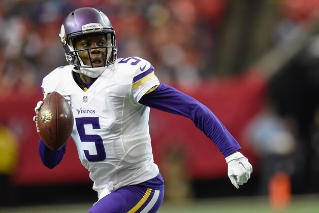 Nov 29, 2015; Atlanta, GA, USA; Minnesota Vikings quarterback Teddy Bridgewater (5) rolls out of the pocket against the Atlanta Falcons during the first half at the Georgia Dome. The Vikings defeated the Falcons 20-10. Mandatory Credit: Dale Zanine-USA TODAY Sports