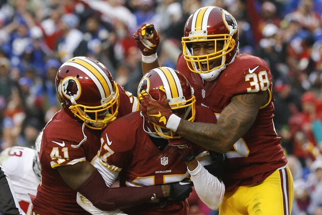 Washington Redskins cornerback Quinton Dunbar, center, is mobbed by his teammates cornerback Will Blackmon (41) and free safety Dashon Goldson (38) after he intercepted a pass in the end zone intended for New York Giants wide receiver Rueben Randle during the second half of an NFL football game in Landover, Md., Sunday, Nov. 29, 2015. (AP Photo/Patrick Semansky) Washington Redskins cornerback Quinton Dunbar, center, is mobbed by his teammates cornerback Will Blackmon (41) and free safety Dashon Goldson (38) after he intercepted a pass in the end zone intended for New York Giants wide receiver Rueben Randle during the second half of an NFL football game in Landover, Md., Sunday, Nov. 29, 2015. (AP Photo/Patrick Semansky)