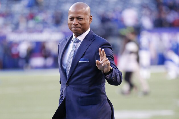 New York Giants general manager Jerry Reese gestures to fans before an NFL football game against the New England Patriots Sunday Nov. 15, 2015, in East Rutherford, N.J. (AP Photo/Julio Cortez)